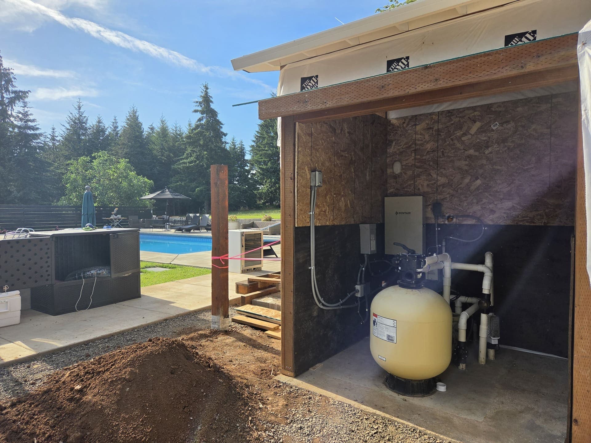 A pool equipment shelter with the disconnect and controls mounted and conduit run to the pump