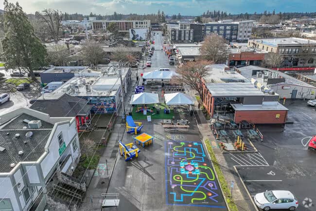 Aerial view of downtown Beaverton, Oregon, over the low storefronts and painted plaza at the centre of town
