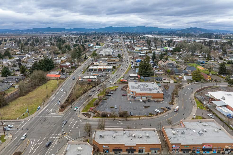 Aerial view along the highway running through Cornelius, Oregon, with farmland on the valley floor beyond
