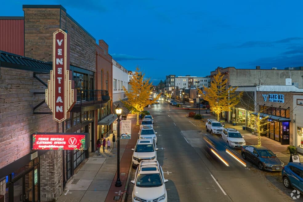 The lit Venetian Theatre sign over Main Street in downtown Hillsboro, Oregon, at dusk