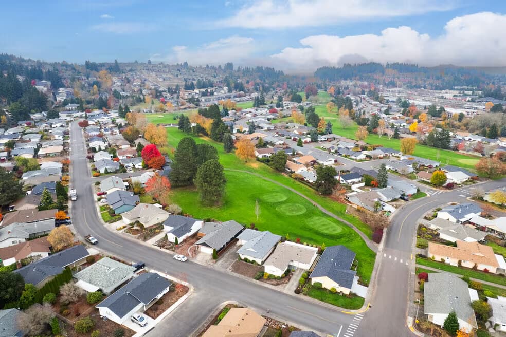 Aerial view of single storey homes around the golf course at King City, Oregon, in autumn