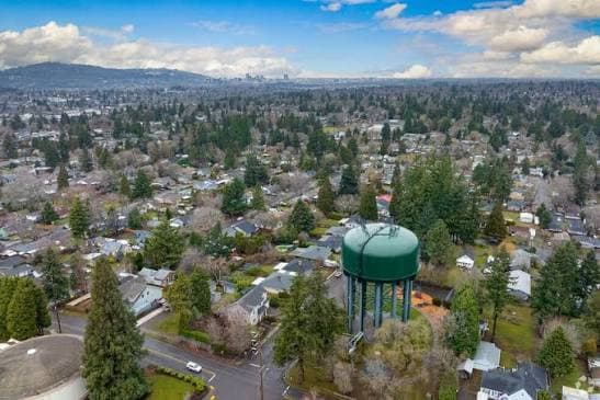 Aerial view over Milwaukie, Oregon, with the city water tower in the foreground and the Portland skyline on the horizon