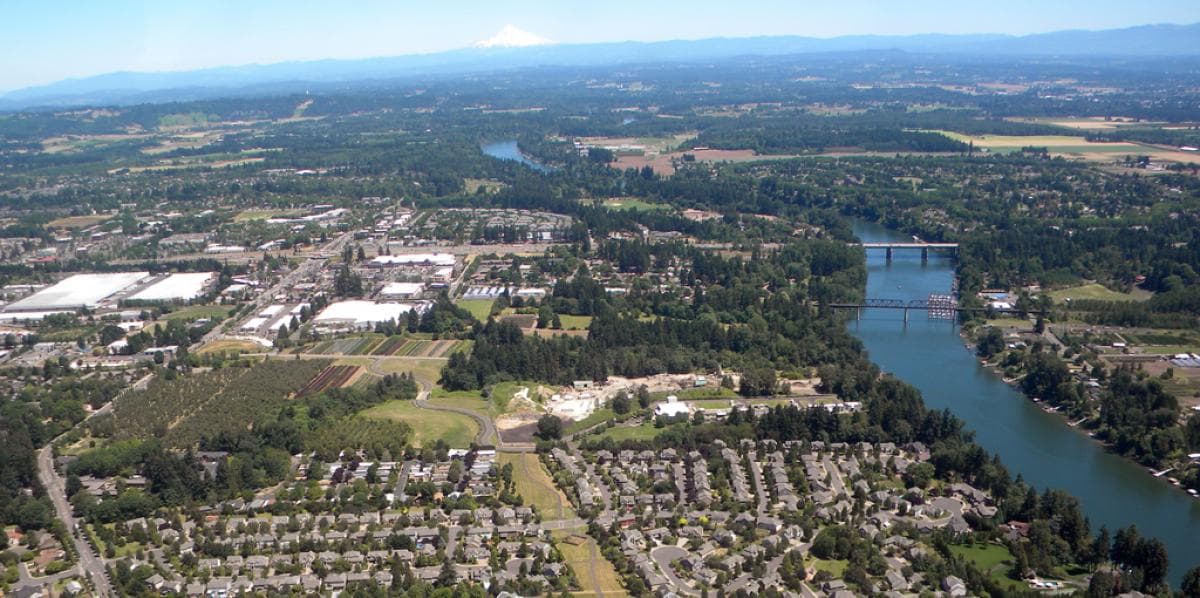 Aerial view over Wilsonville, Oregon, with the Willamette River to the right and Mount Hood on the horizon