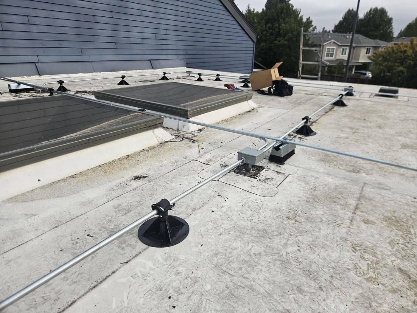 Conduit run across a flat commercial roof on raised supports