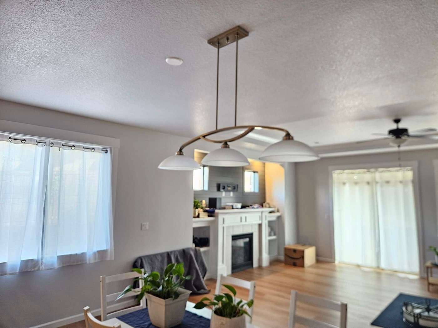 Custom kitchen lighting with a linear pendant centred over the island and recessed ceiling lights