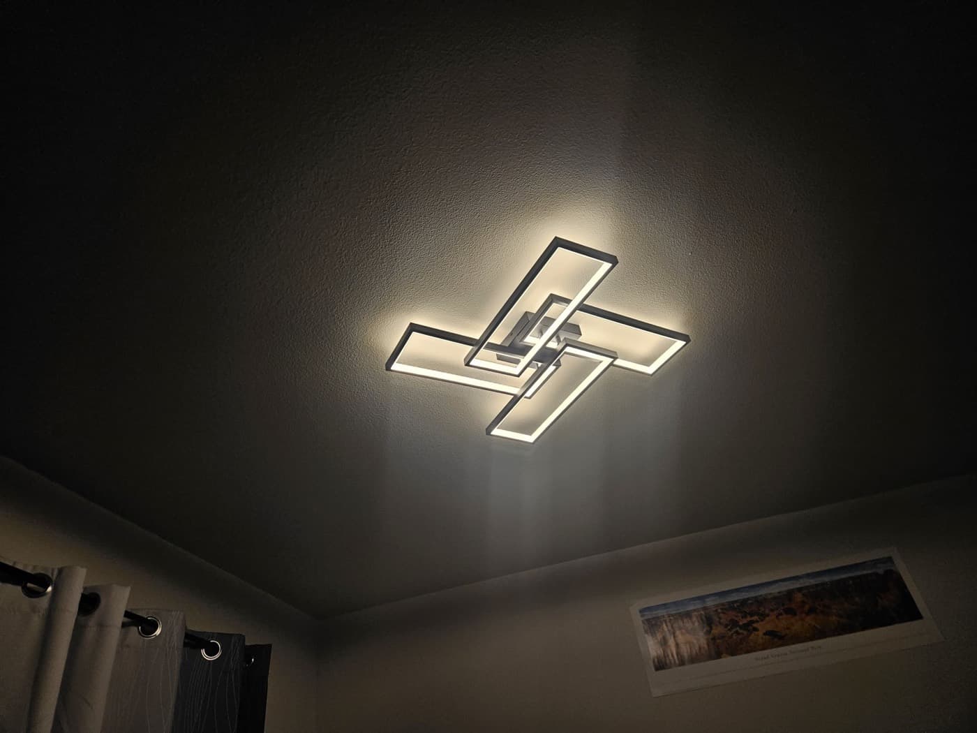 Modern low profile LED ceiling fixture installed in a living room