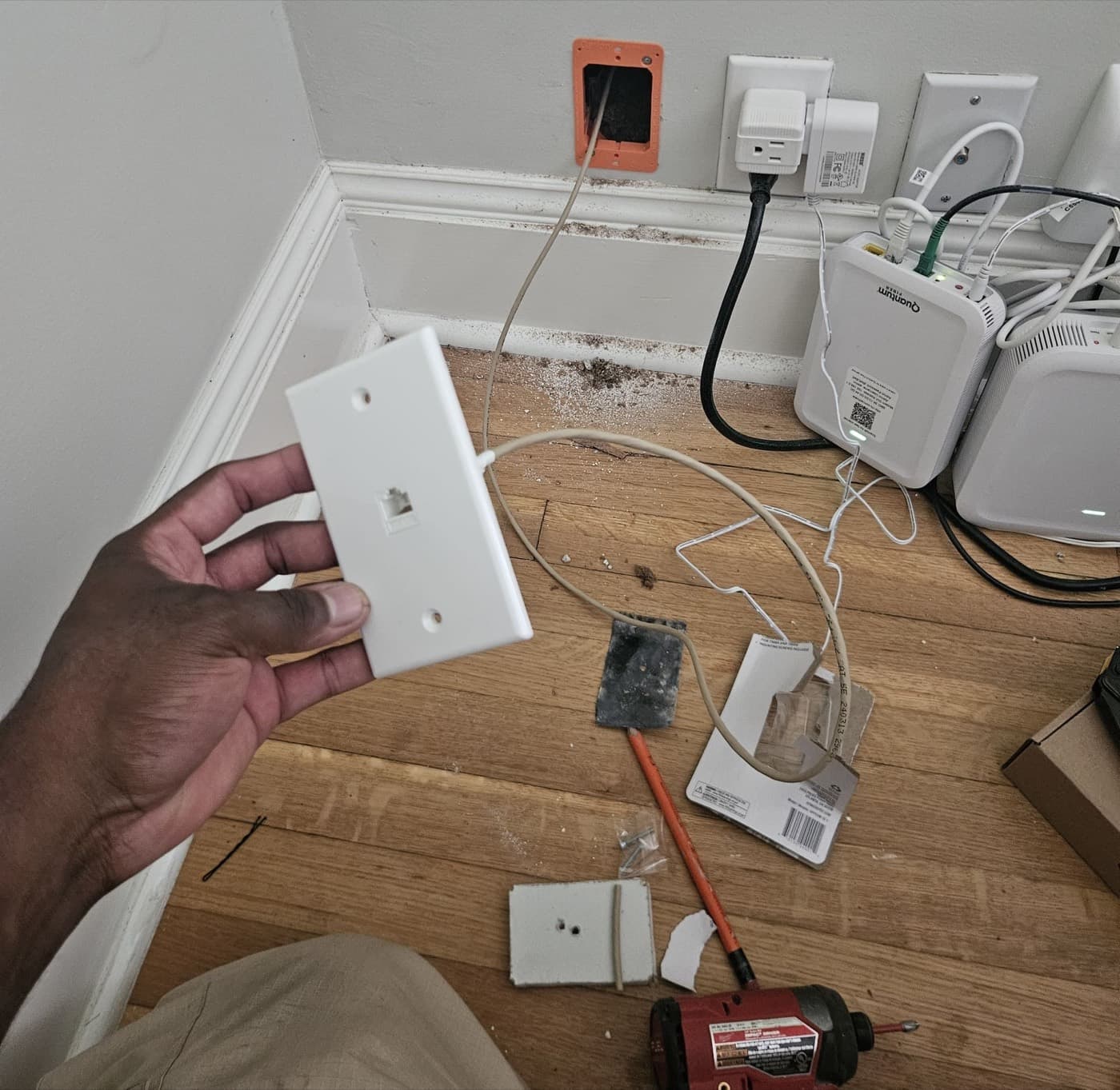 Low voltage wall plate trimmed out with the data cable landed behind it