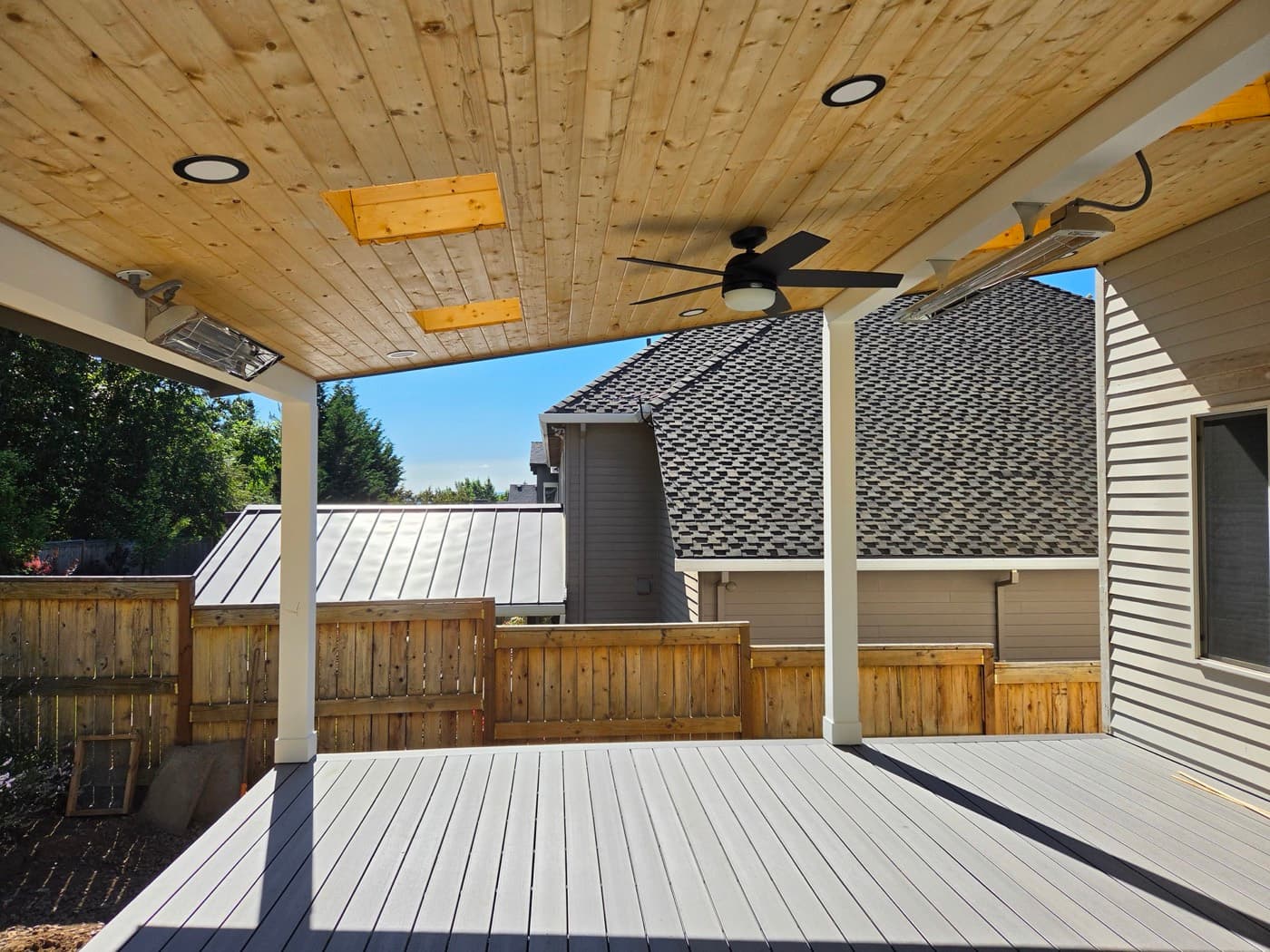 Covered patio with recessed lighting and a ceiling fan set into a cedar ceiling
