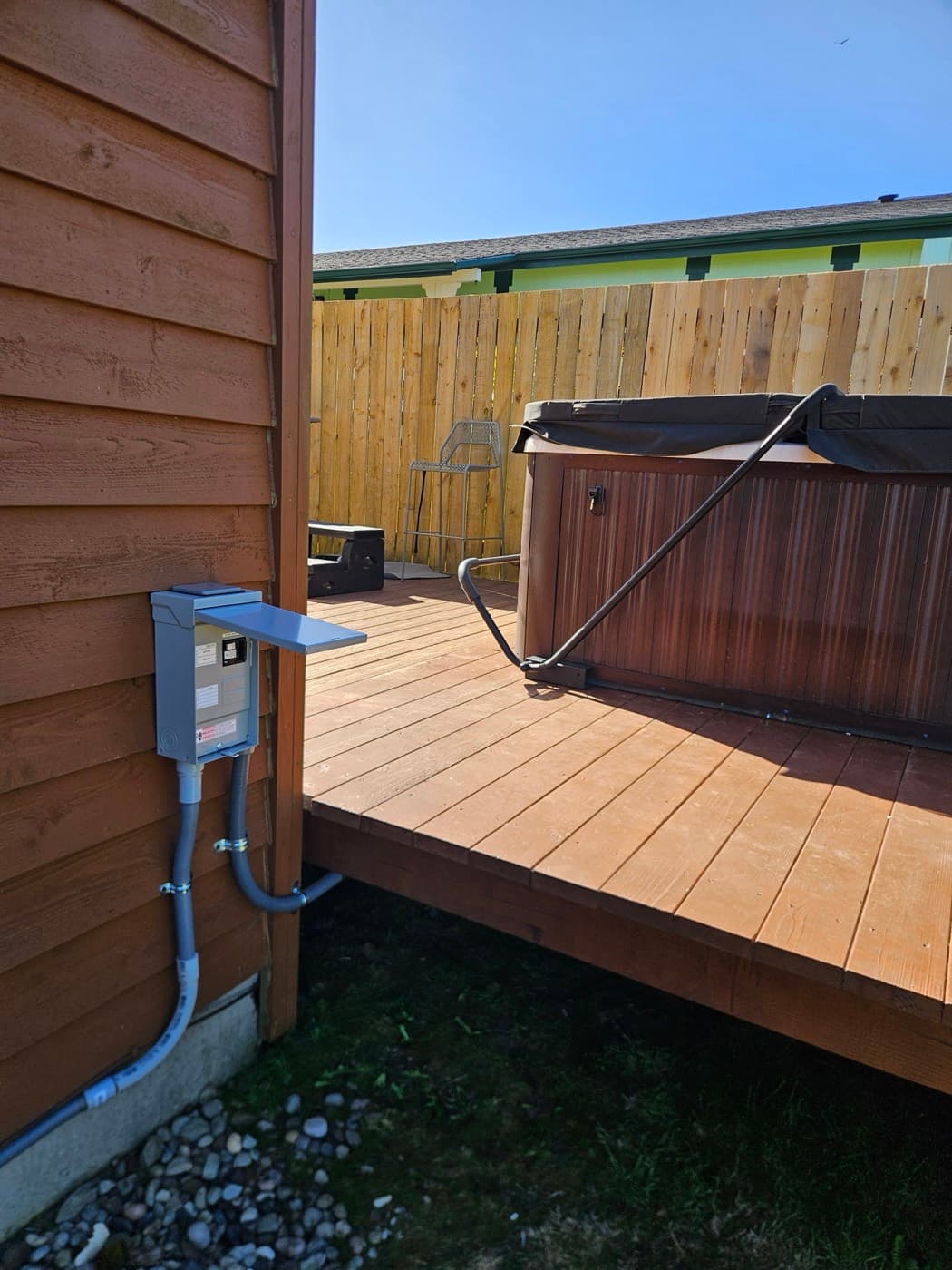 Hot tub wired on a deck with its disconnect mounted within sight of the tub