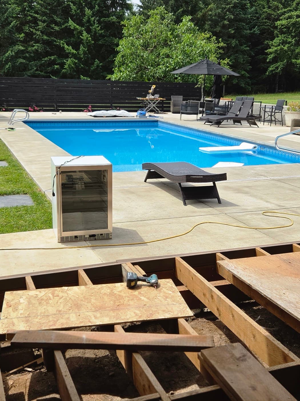 Poolside deck with power run in for an outdoor refrigerator during a deck build