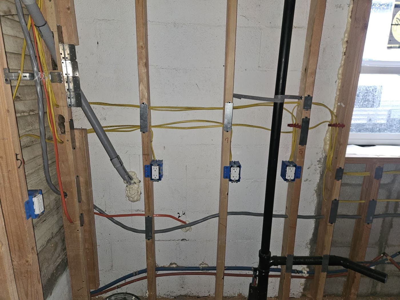 New construction electrical rough in with boxes set and cable run through open joists