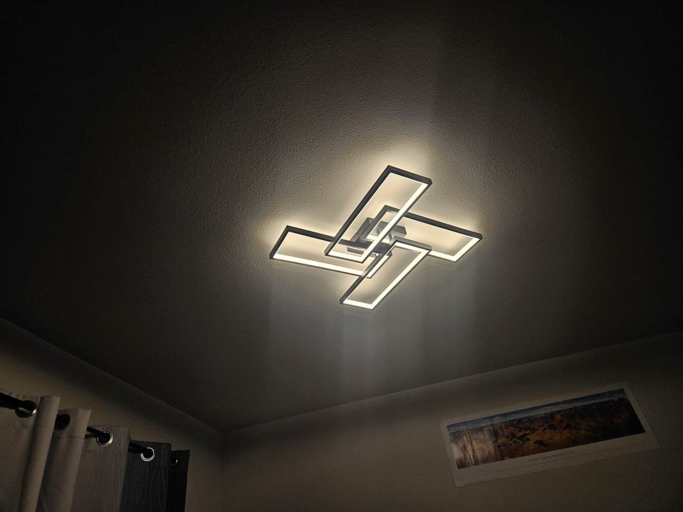 An interlocking rectangular LED flush mount glowing against a white ceiling
