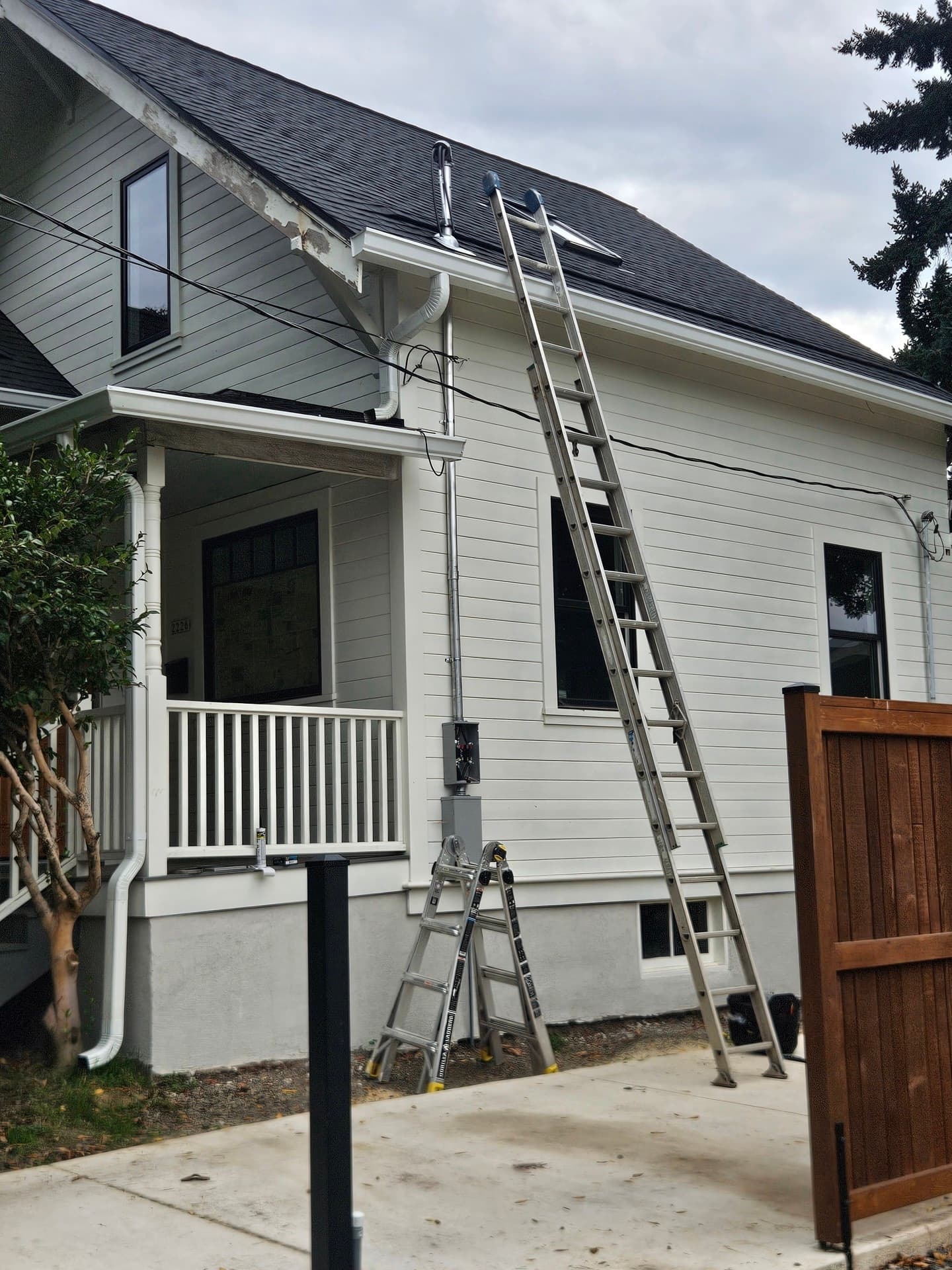 A new meter base and service mast on the side of a house, landed and sealed